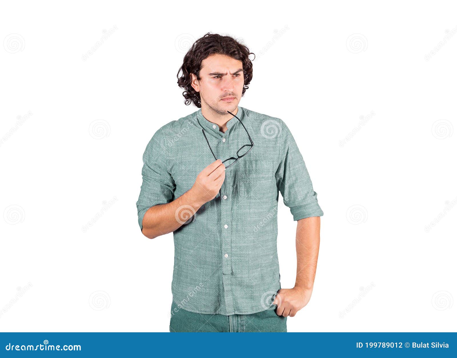 confused young man, long curly hair style, holds eyeglasses in his hand, thoughtful gesture, looking suspicious aside  on