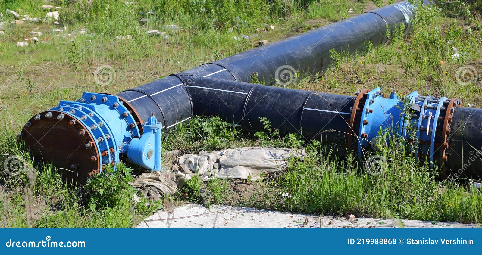 Connecting Large Diameter Black Sewer Pipes in Green Grass Stock Photo