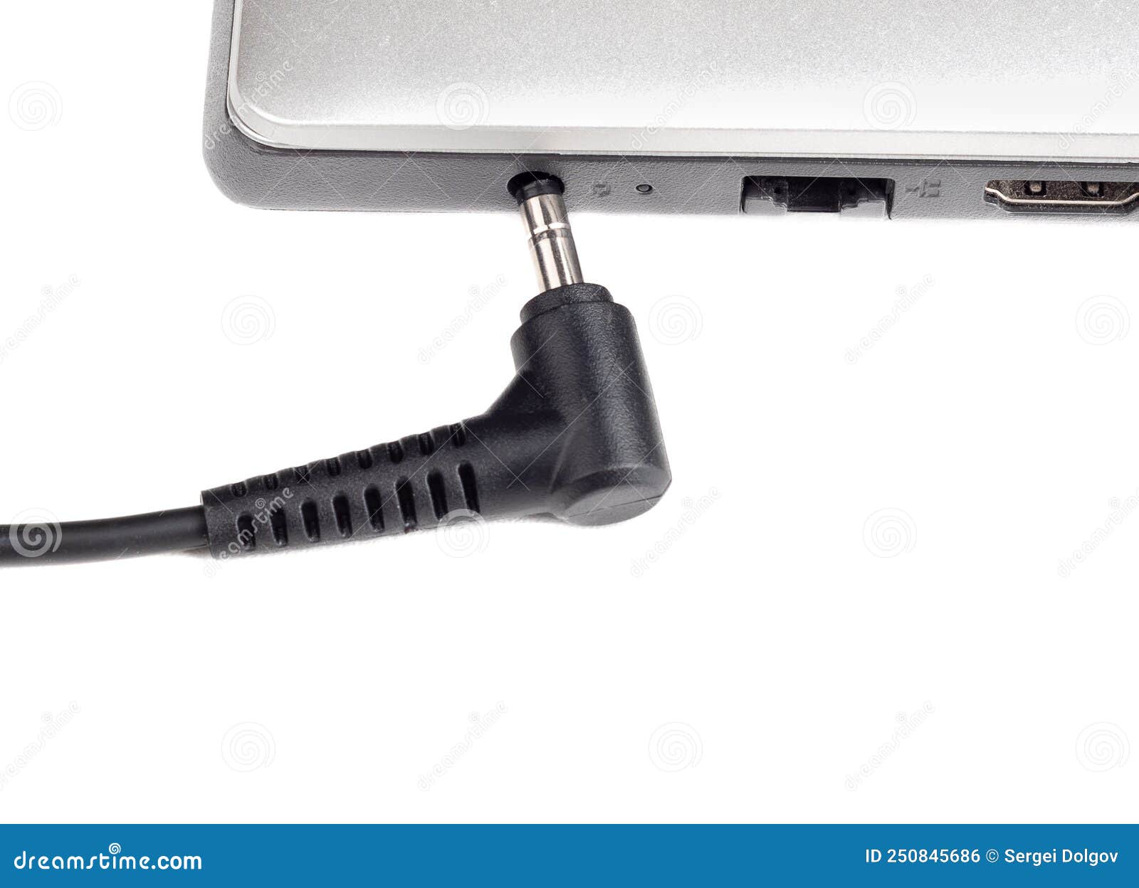Connecting the Power Adapter To a Laptop on a White Background. Stock