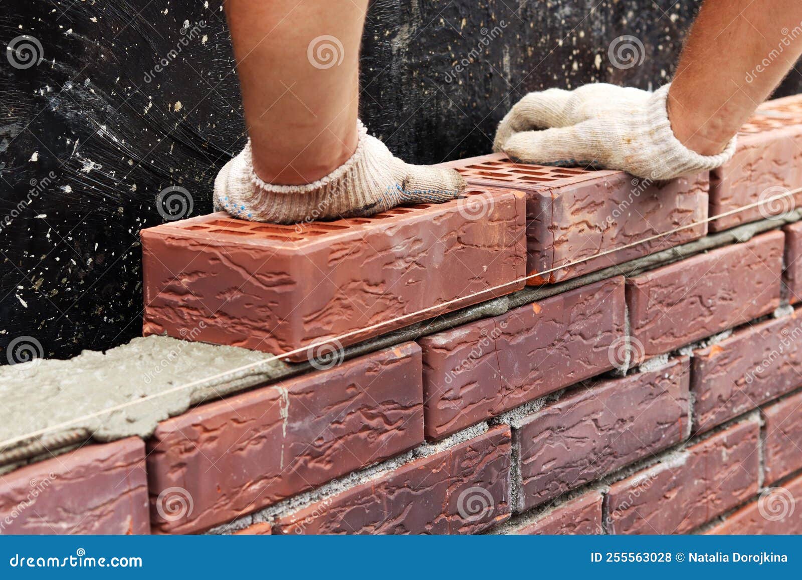 Construction of a Brick Wall. Bricklaying. a Worker Builds a Brick Wall