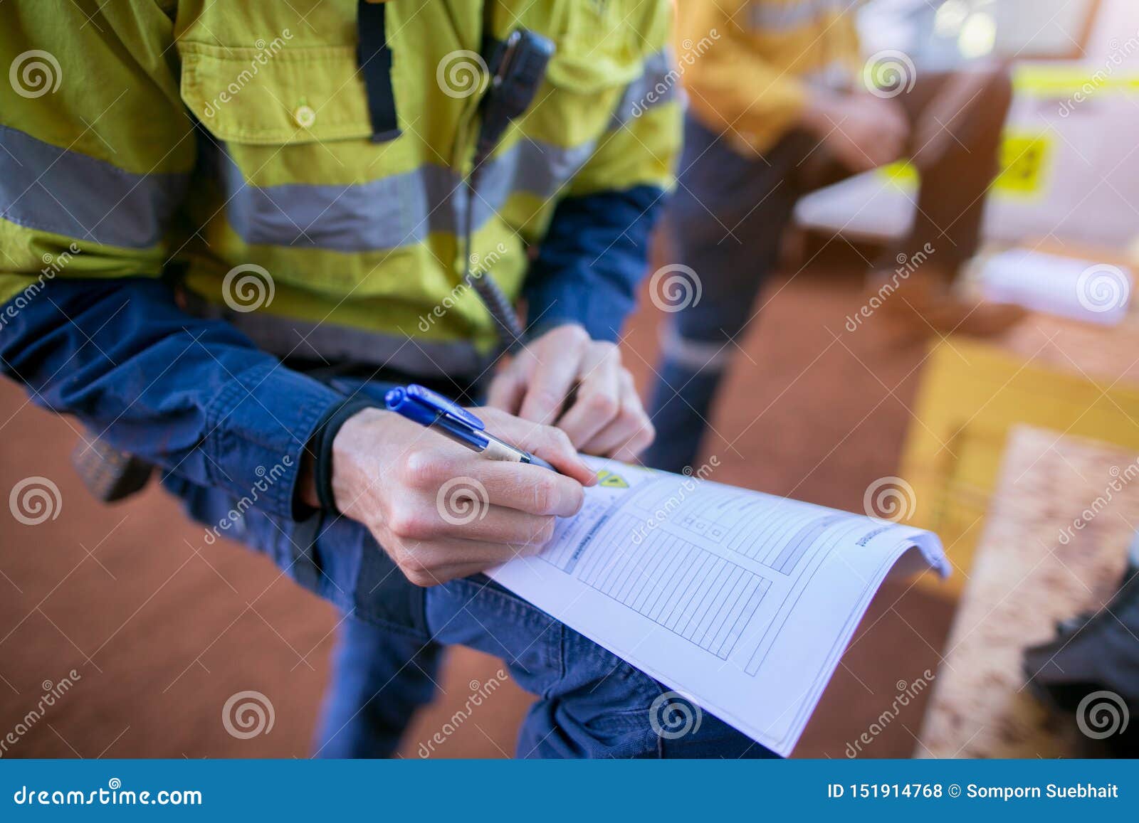 construction coal miner supervisor conducting safety checking on job hazards analysis on hot work permit before sign off