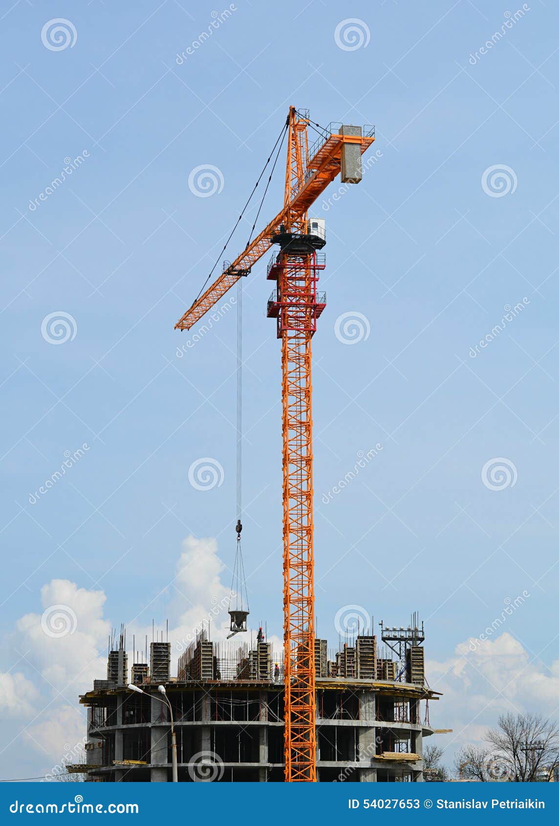 Construction Crane Lifts Materials To the Object Under Construction