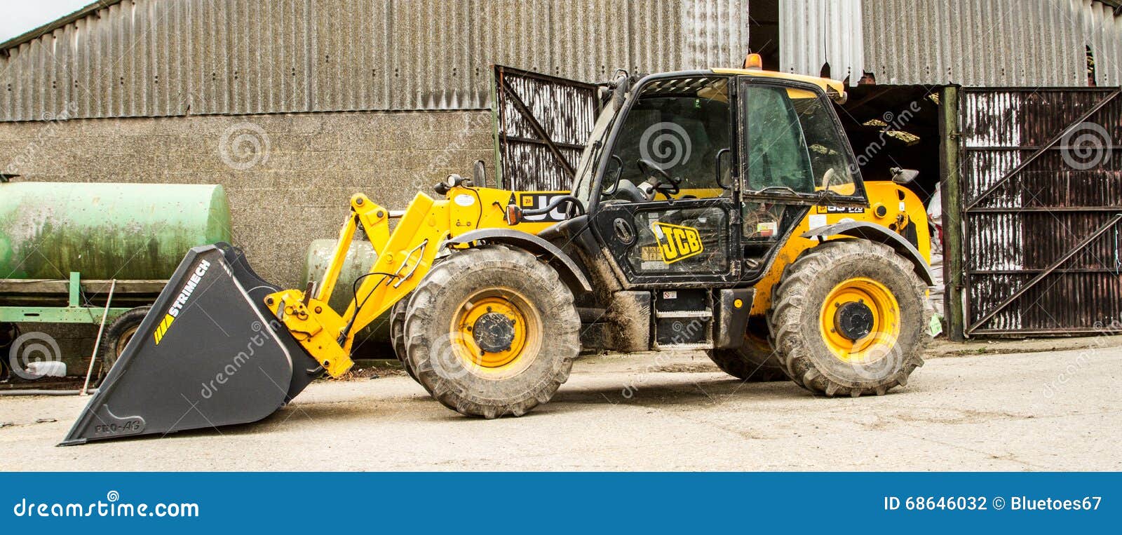 Construction Digger Loader in Farm Yard with Barn Editorial Photography