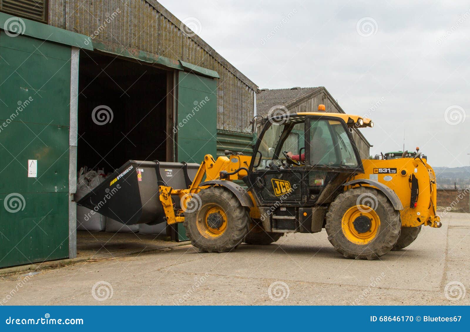 construction-digger-loader-farm-yard-barn-yellow-jcb-bulldozer-bags-crops-68646170.jpg