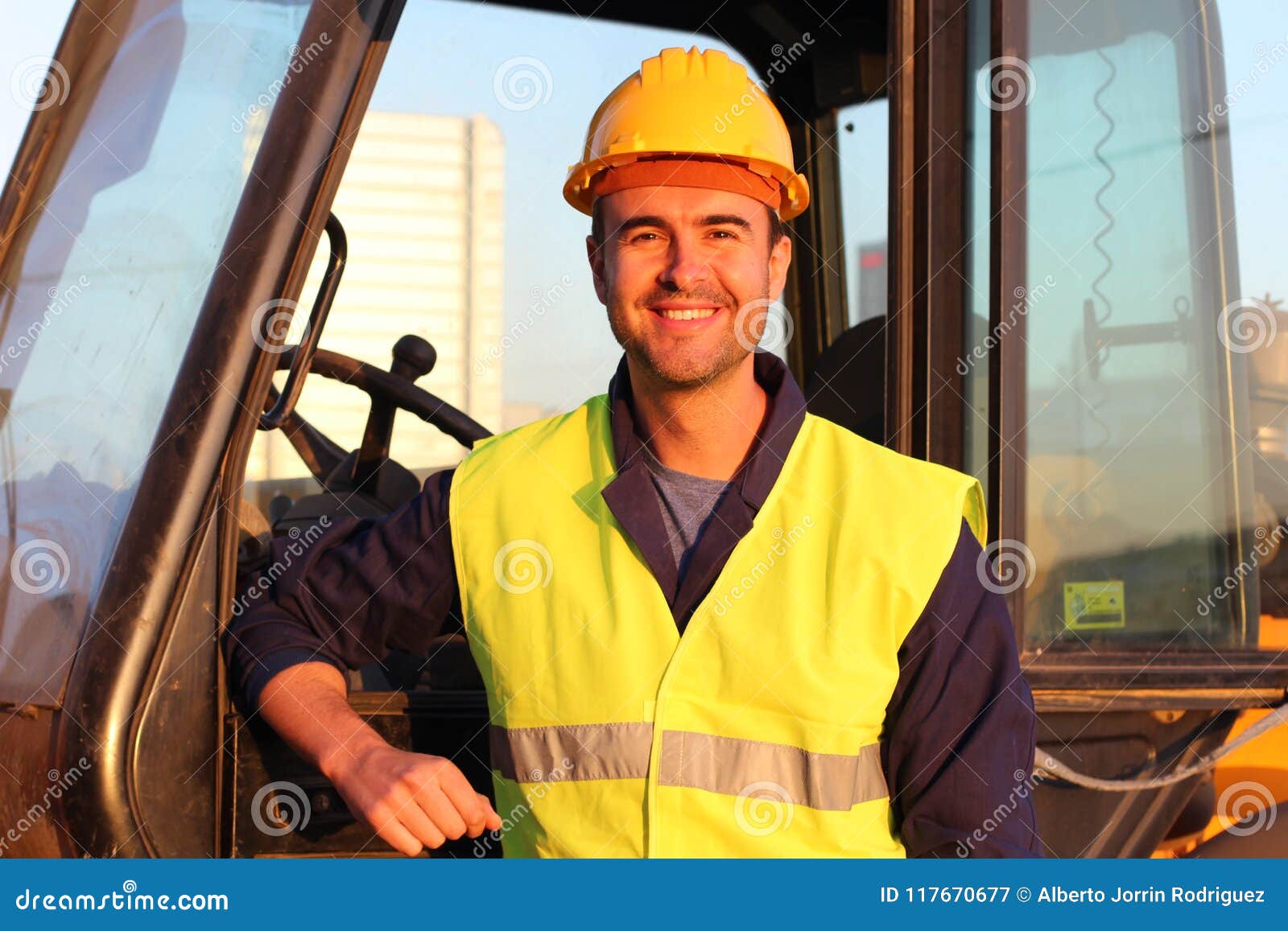 Construction Driver with Excavator on the Background Stock Image