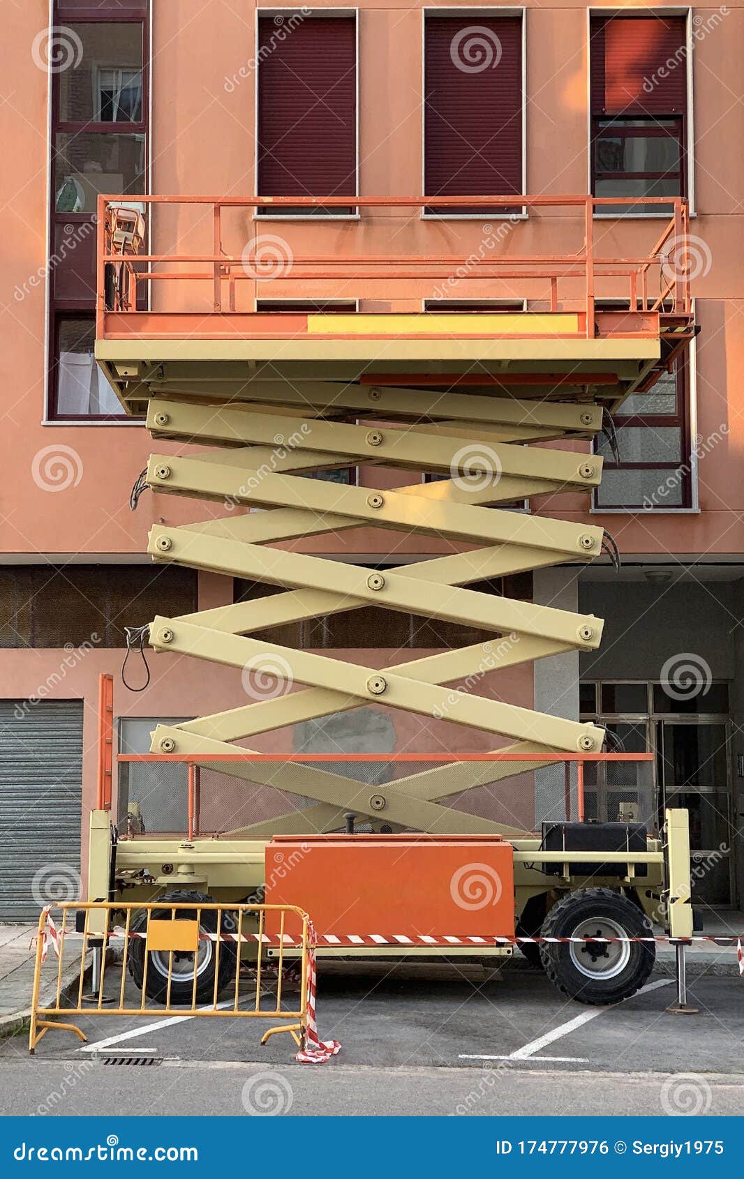 Construction Hydraulic Lift Near a Residential Building Stock Photo