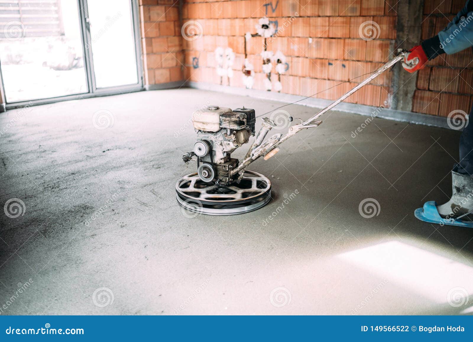 Construction Industrial Worker Finishes Concrete Screed with Trowel
