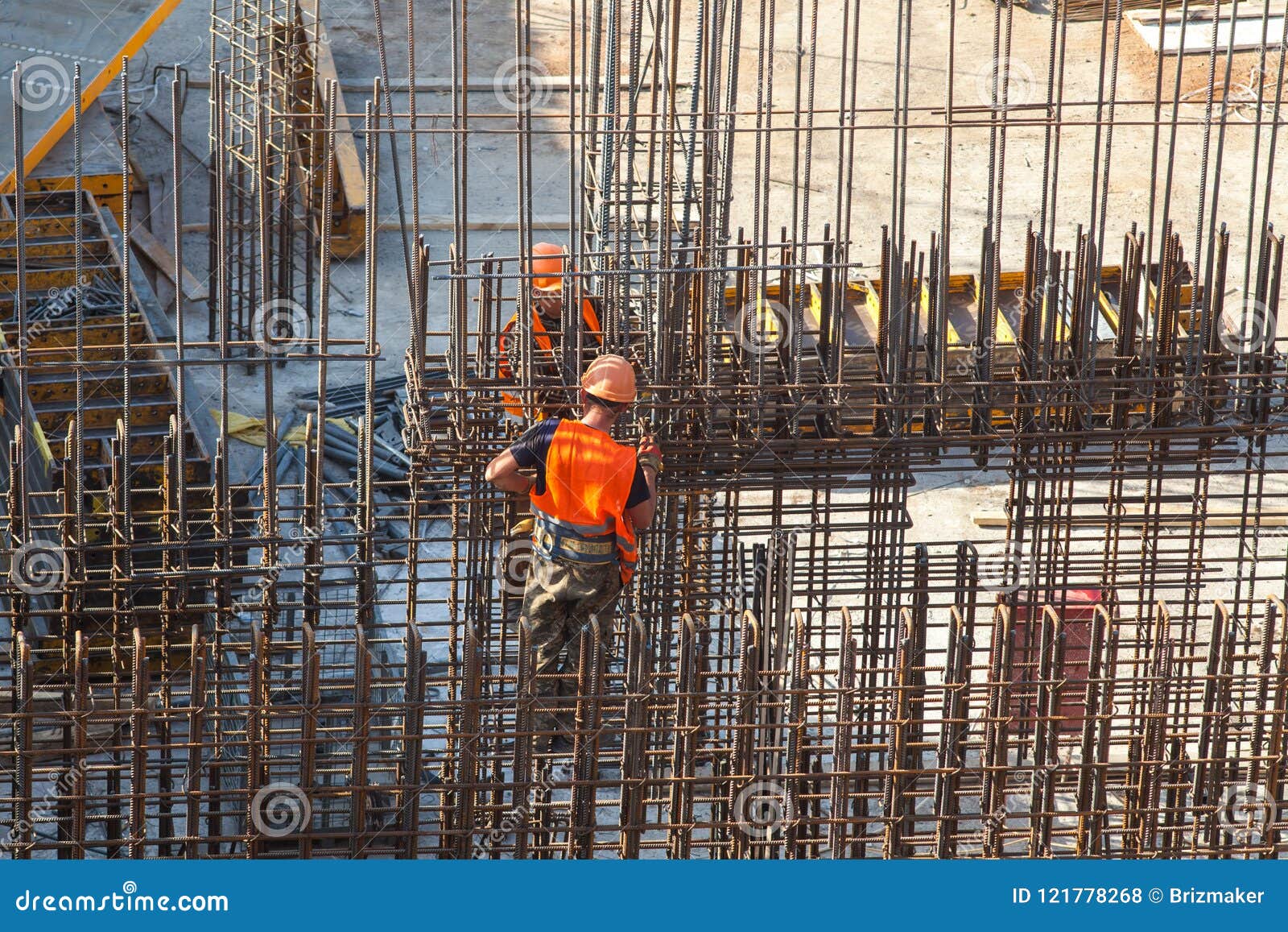 Construction of a Large Commercial Building. Worker Connects the
