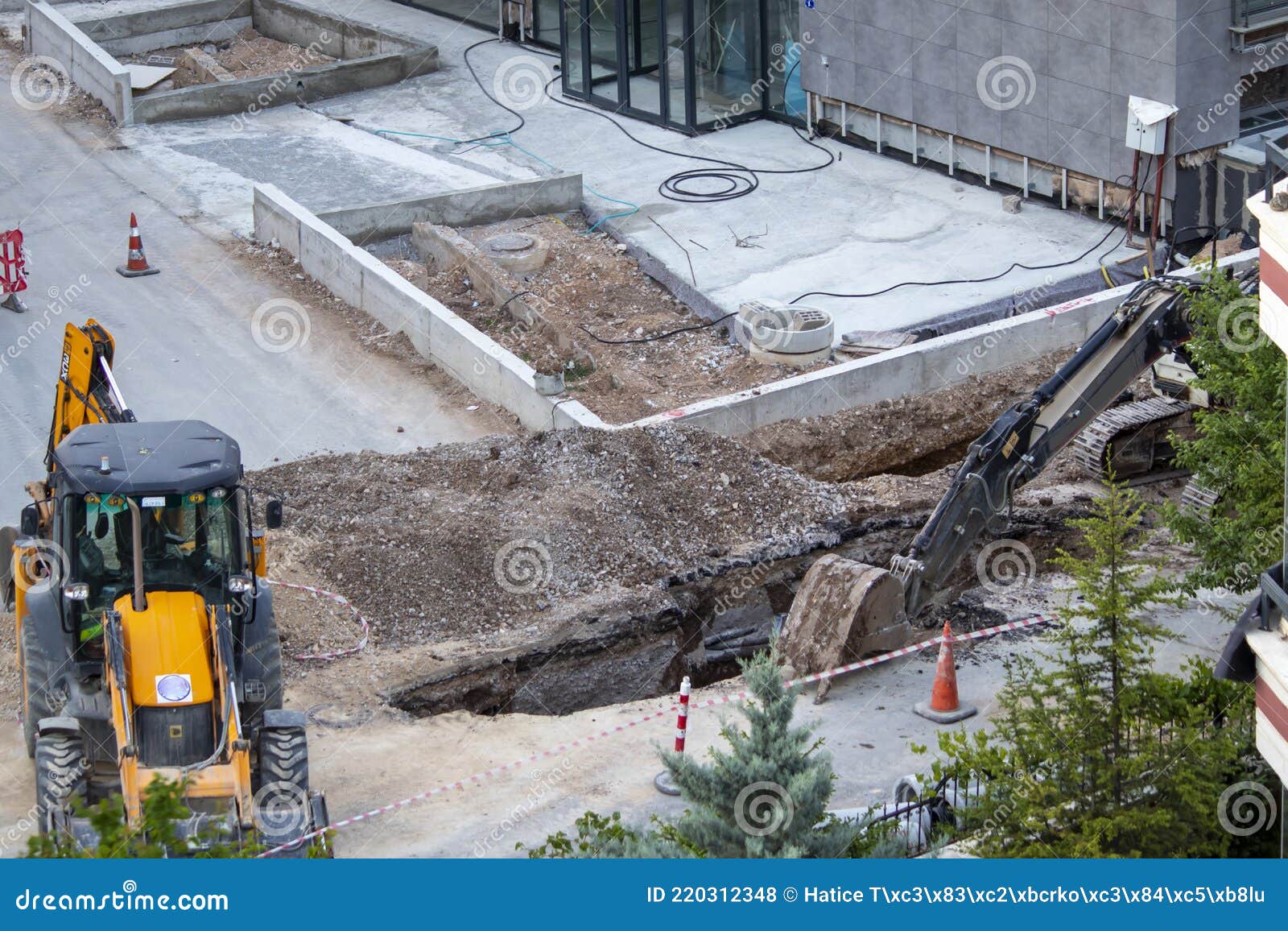 Construction Machinery Working on the Road. they are Doing Sewer System ...