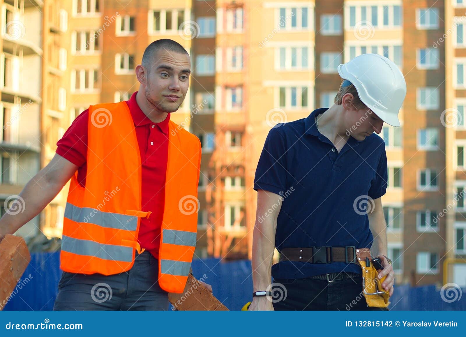Construction Manager and Engineer Working on Building Site Stock Photo