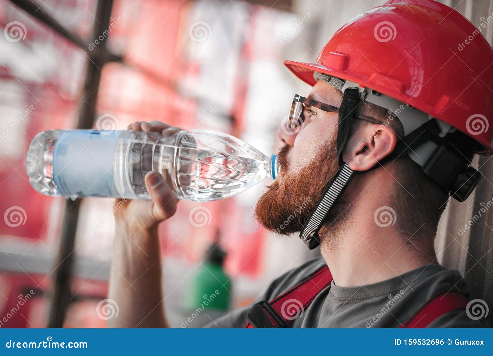 Construction Mason Worker on Scaffolding, Resting and Drinking Water