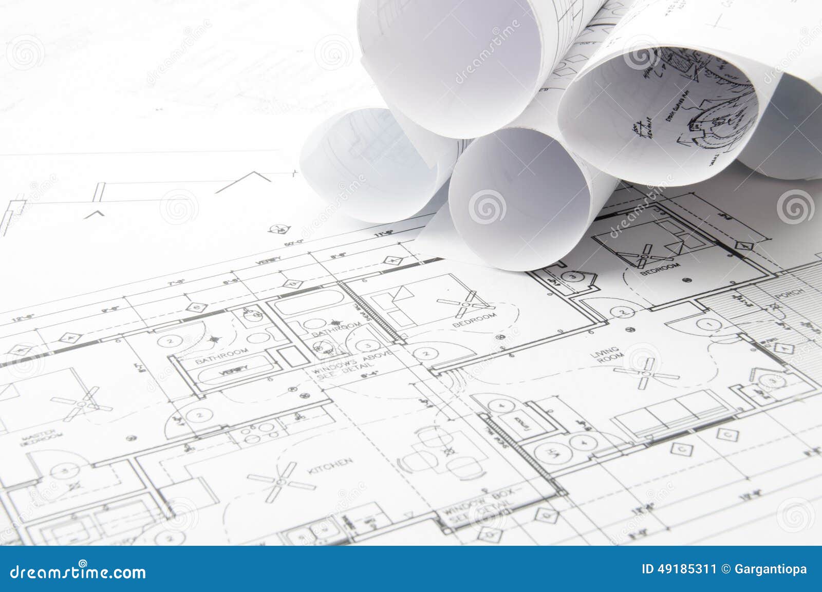 Construction planning drawings on the table and two yellow pencils