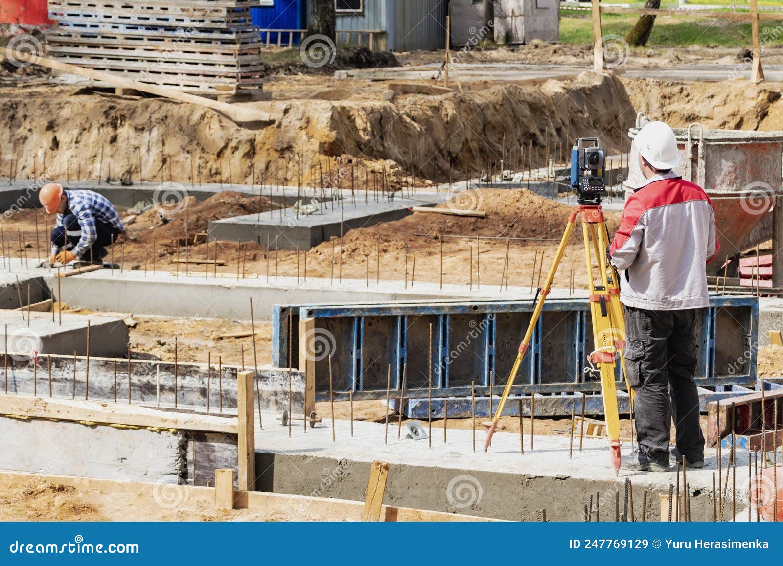 construction of a residential area. geodetic stakeout. surveyor at a large construction site. a man with a tachometer during work