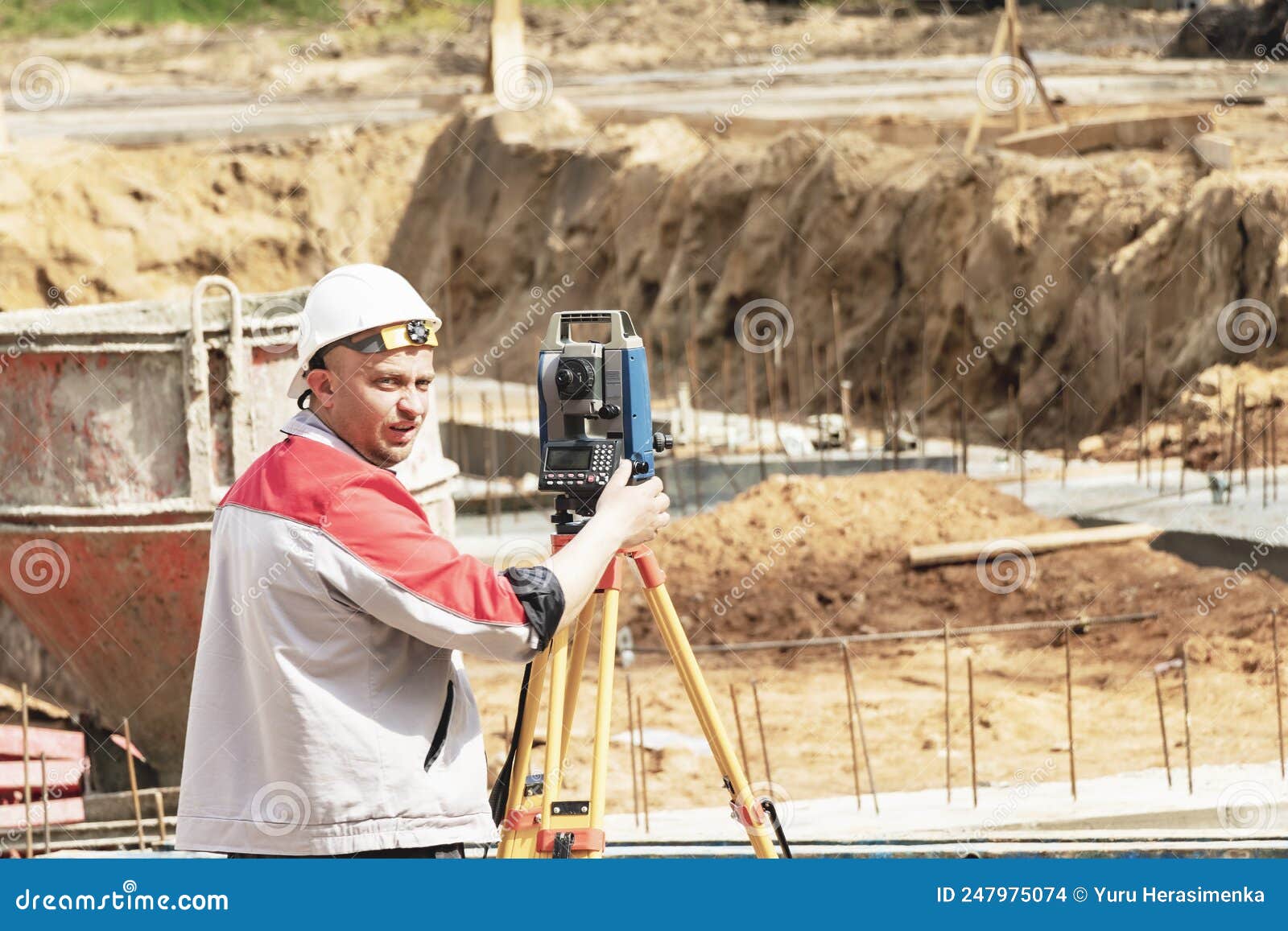 construction of a residential area. geodetic stakeout. surveyor at a large construction site. a man with a tachometer during work