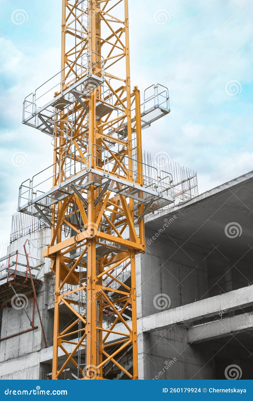 Construction Site with Tower Crane Near Unfinished Building Stock Photo