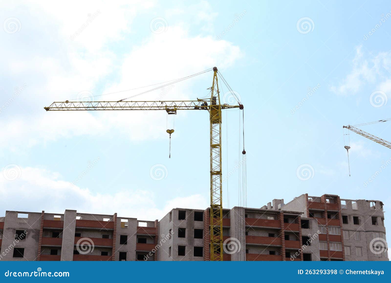 Construction Site with Tower Crane Near Unfinished Building Stock Photo