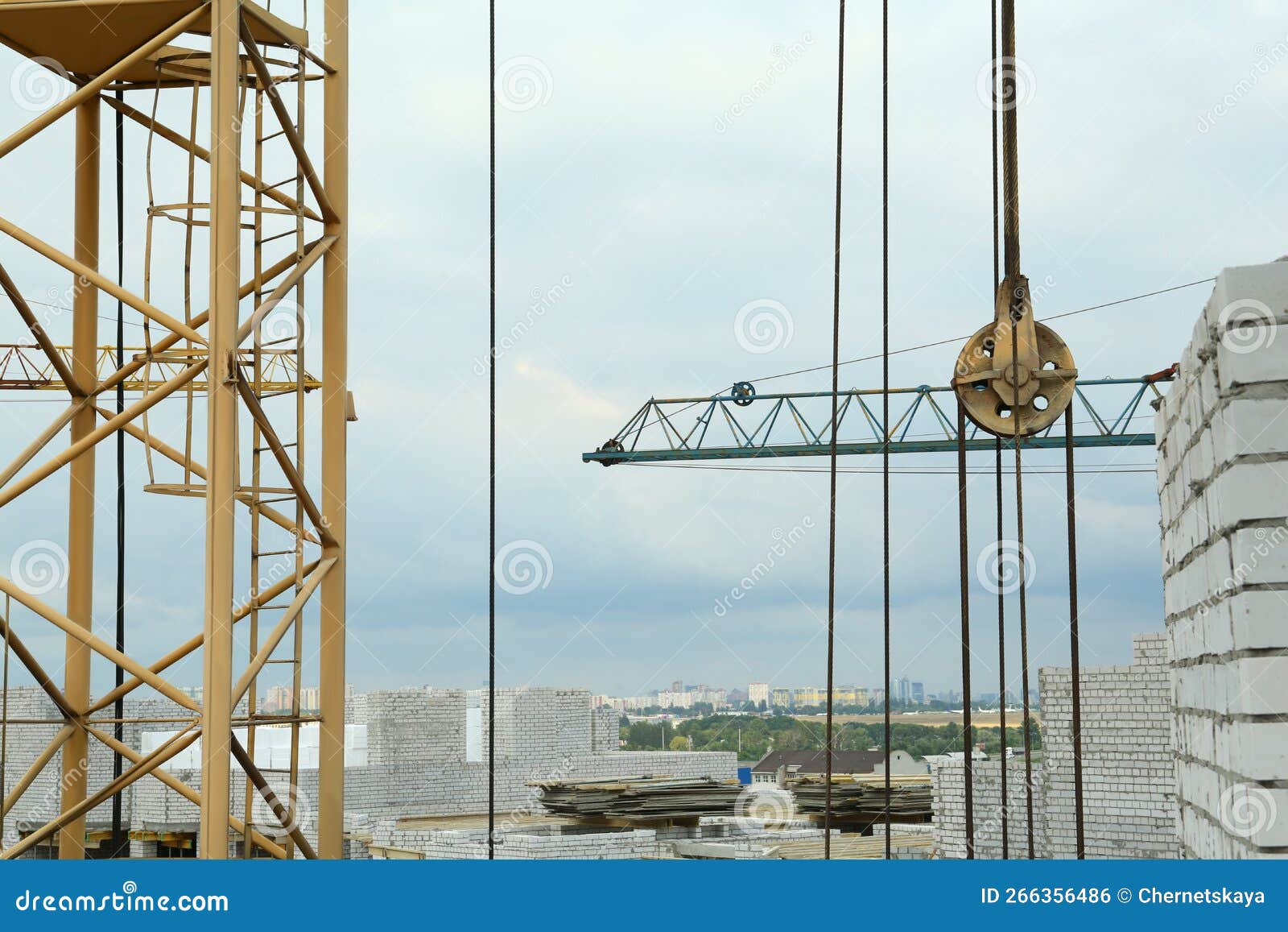 Construction Site with Tower Crane Near Unfinished Building Stock Photo
