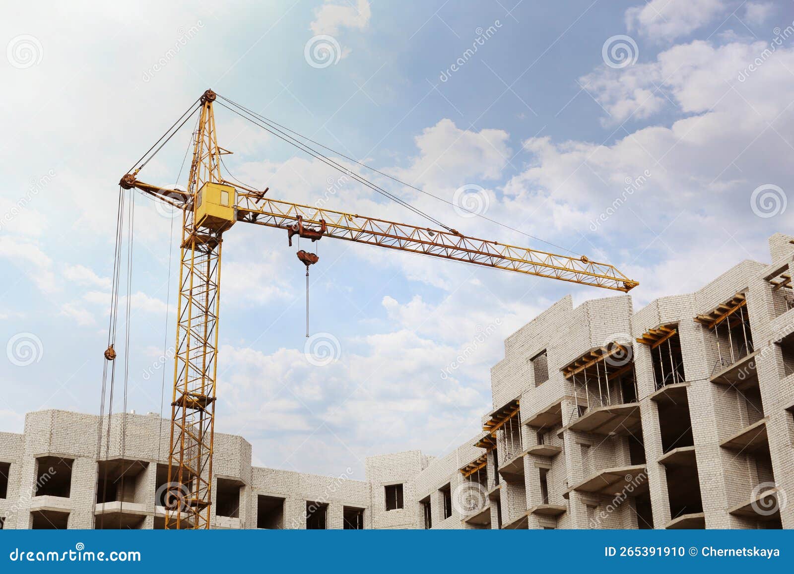 Construction Site with Tower Crane Near Unfinished Building, Low Angle