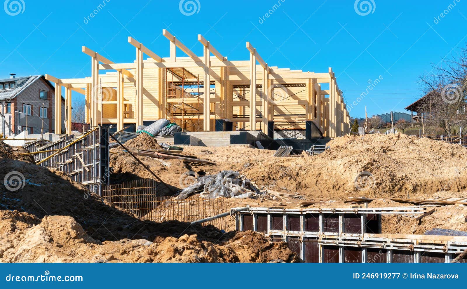 construction site of a wooden house made of double profiled timber. the use of formwork when concreting the foundation of the