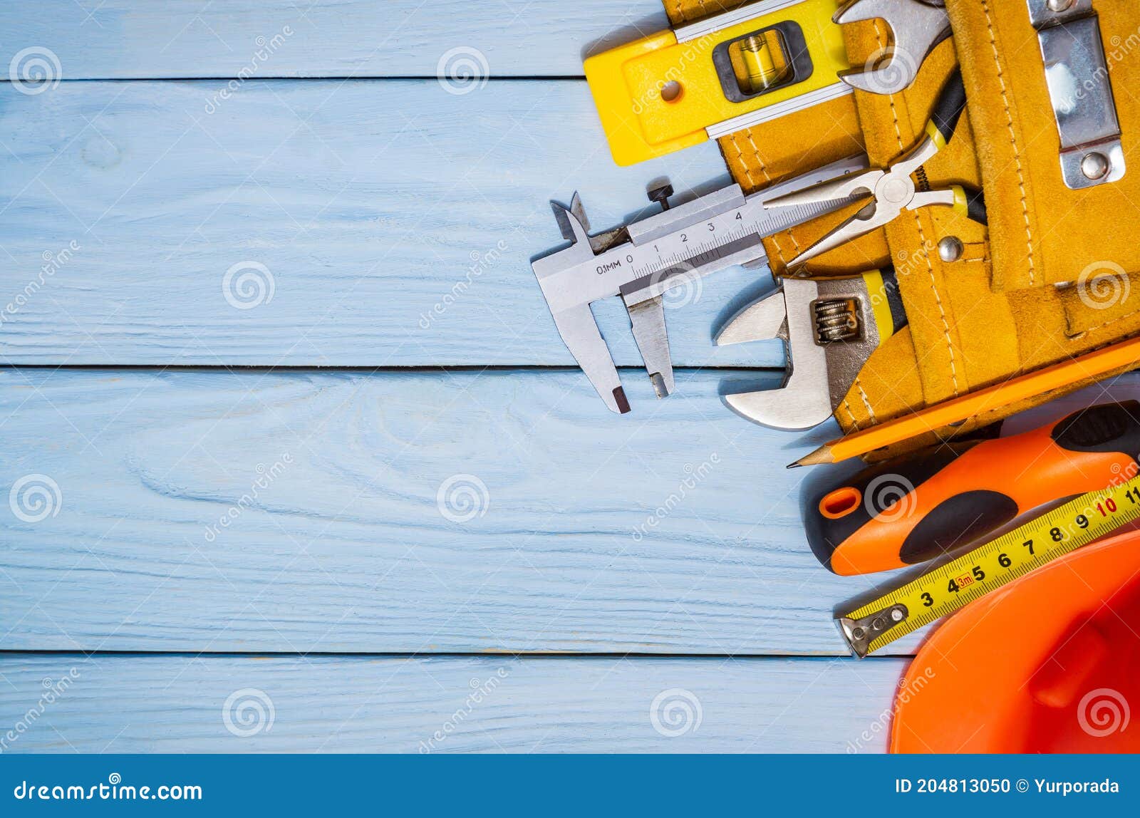 Construction Tool Kit for Builder in Bag on Blue Wooden Boards Also