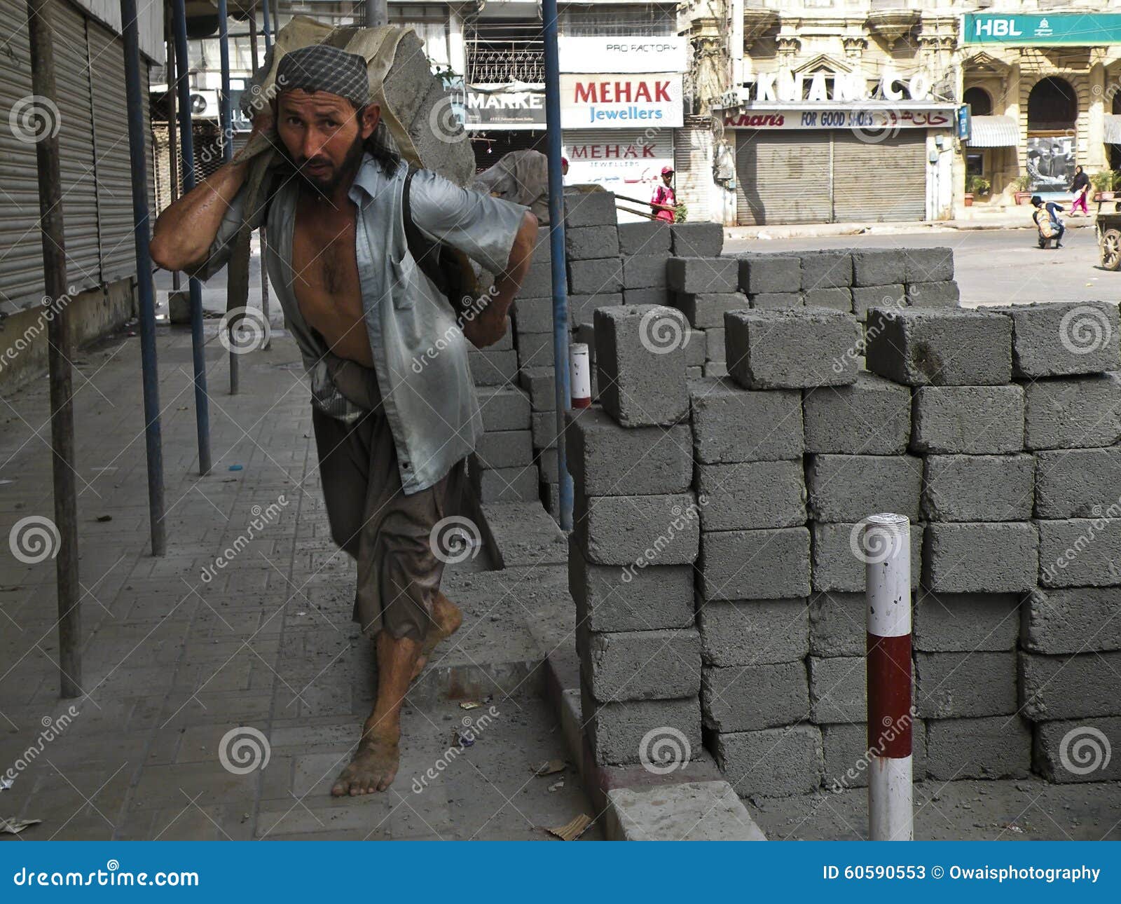 Construction Worker Carrying Concrete Block Editorial Stock Photo