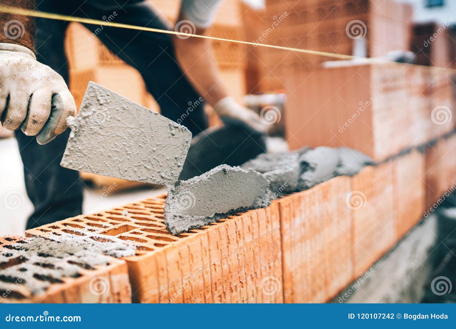 construction worker details, protective gear and trowel with mortar building brick walls