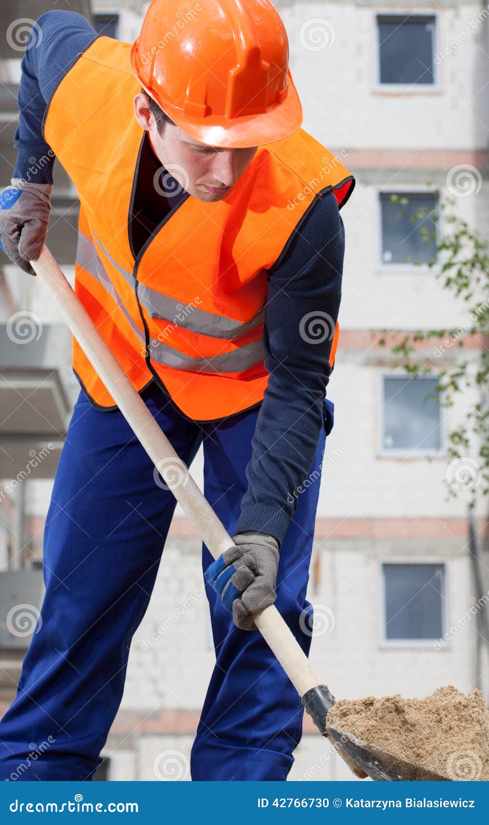 Worker Digging Holes On A Sloping Area To Put Pillars To Build House