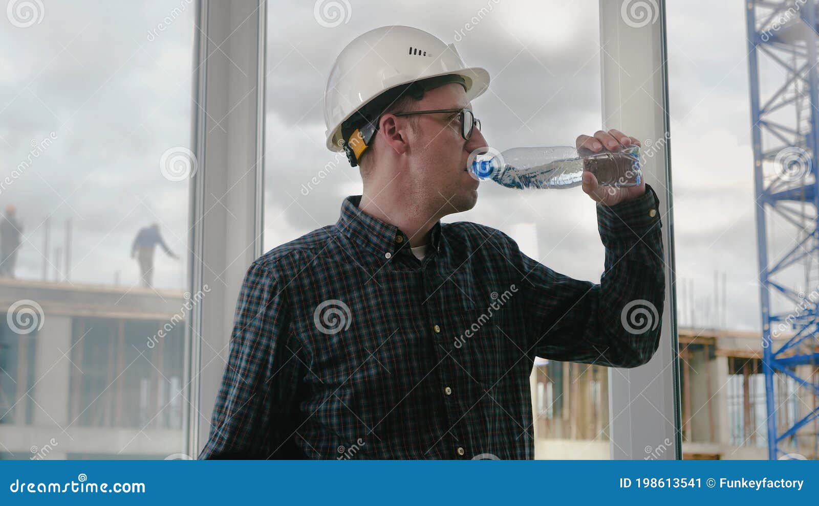 Construction Worker Drinking Water on a Location Site. Stock Image