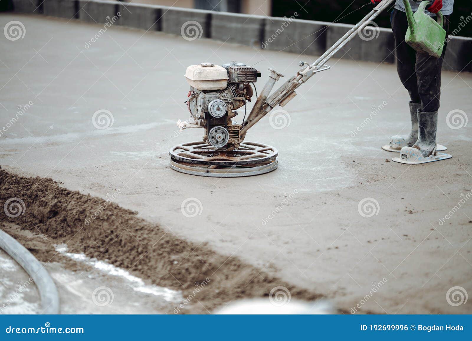 construction worker finishing concrete screed with power trowel machine, helicopter concrete screed  finishing and smoothing