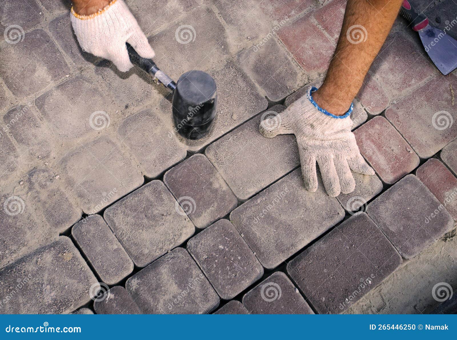 construction worker fixing the pavestone