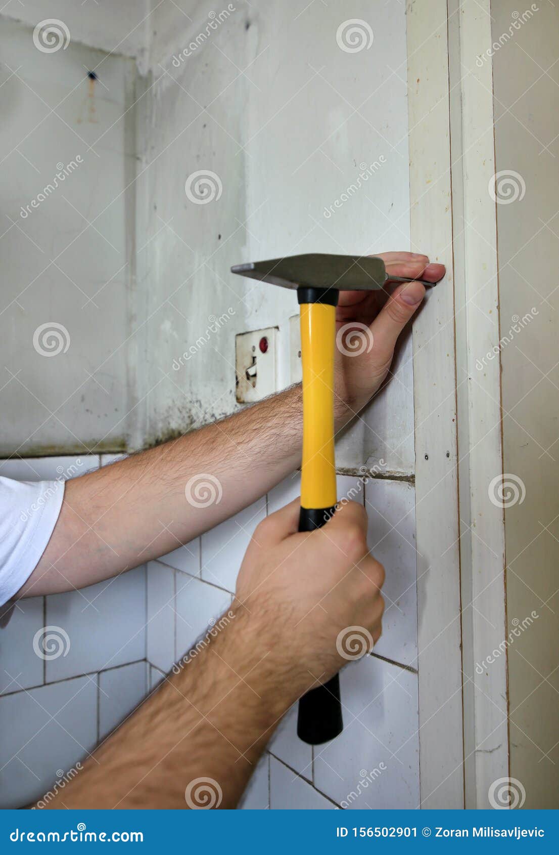 Construction Worker and Handyman with Yellow Hammer Strikes and Nails a Nail into Wooden Wall of Kitchen Door at Construction Site Stock Image - Image of craftsman, contractor: 156502901 Construction Worker and Handyman with Yellow Hammer Strikes and Nails a Nail into Wooden Wall of Kitchen Door at Construction Site Stock Image - Image of craftsman, contractor: 156502901