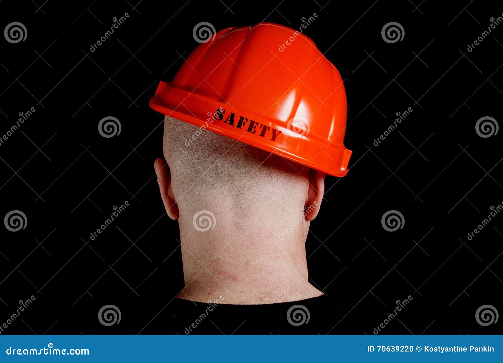 Construction Worker in Hard Hat with an Inscription Safety Stock Photo