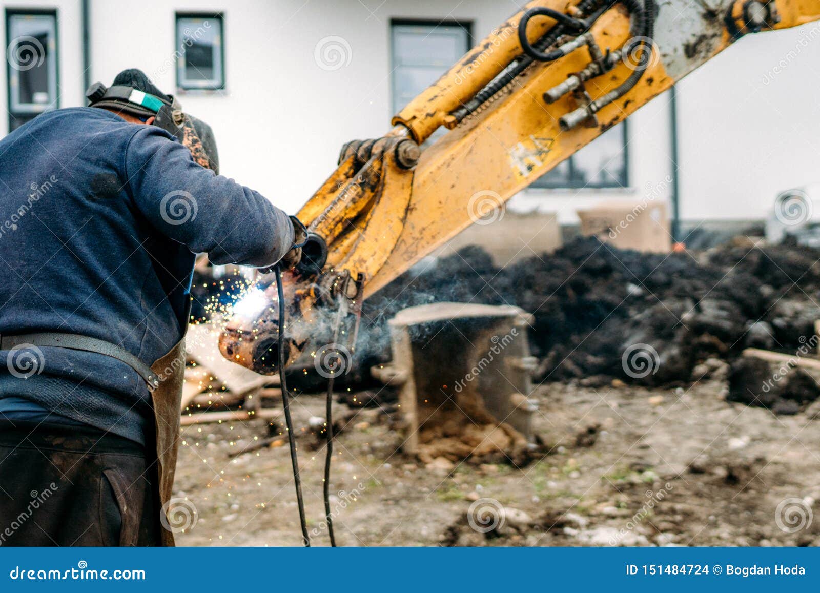 Worker, Laborer, Welding Excavator Arm with Arc Welding Machinery Stock