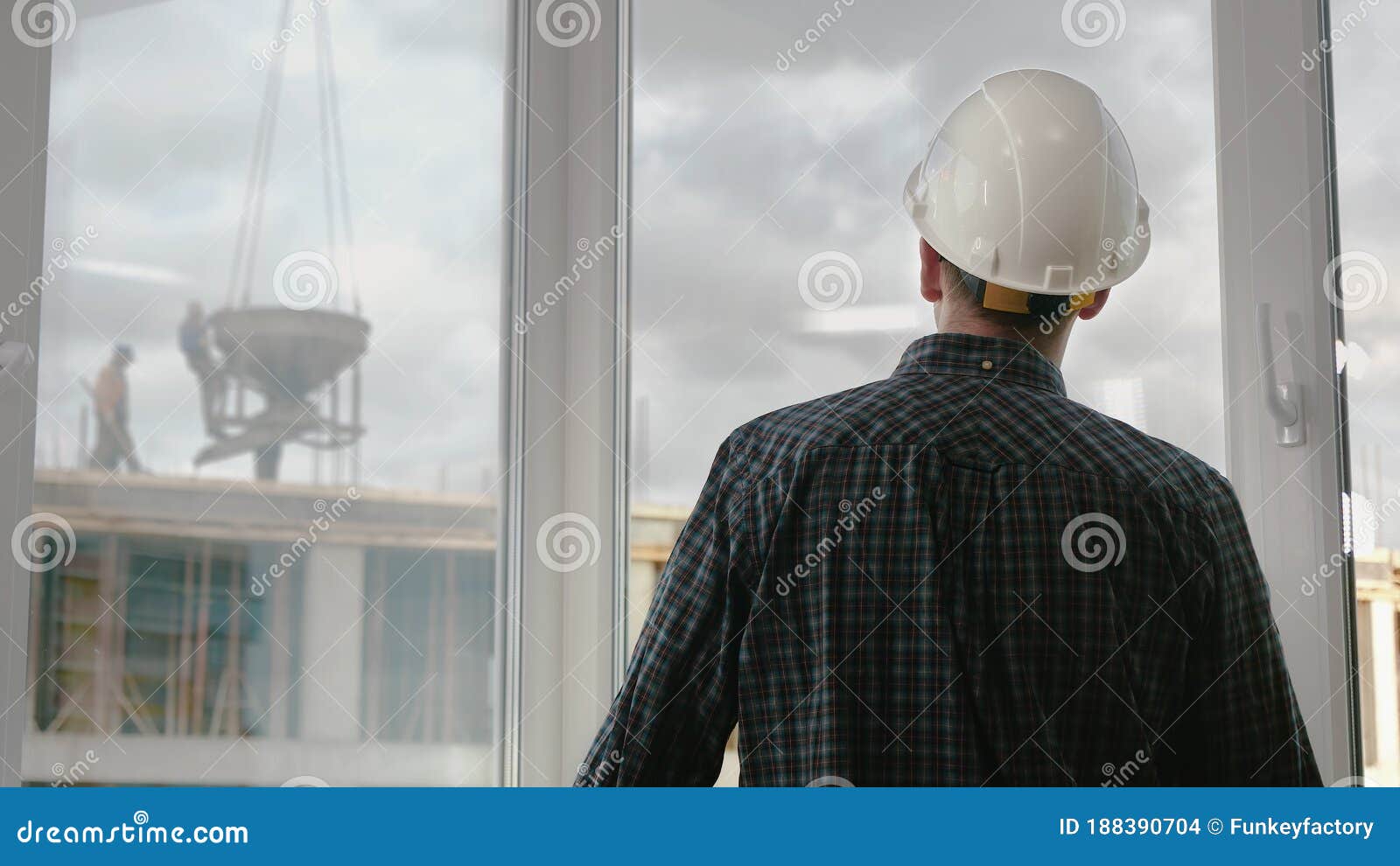 A Construction Worker Looking at Construction Works. Stock Photo