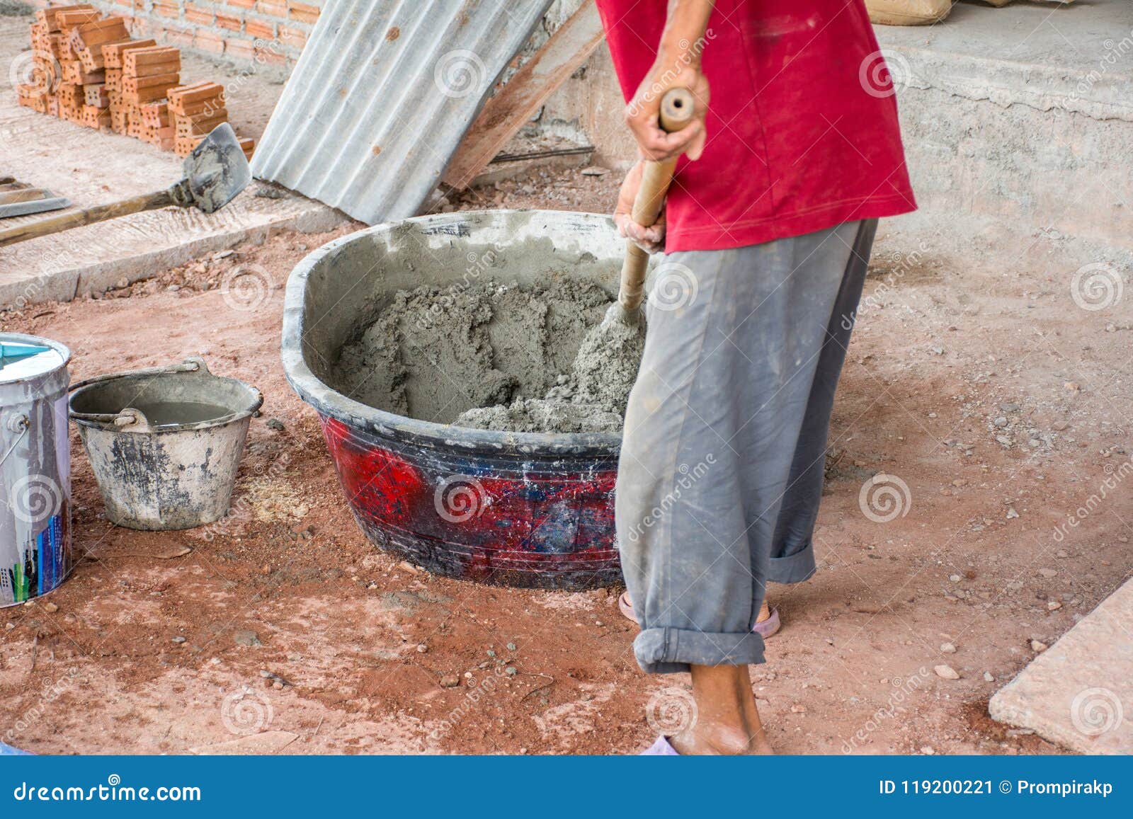 Construction Worker Manually Mixing Concrete in Mixer Tray Stock Image