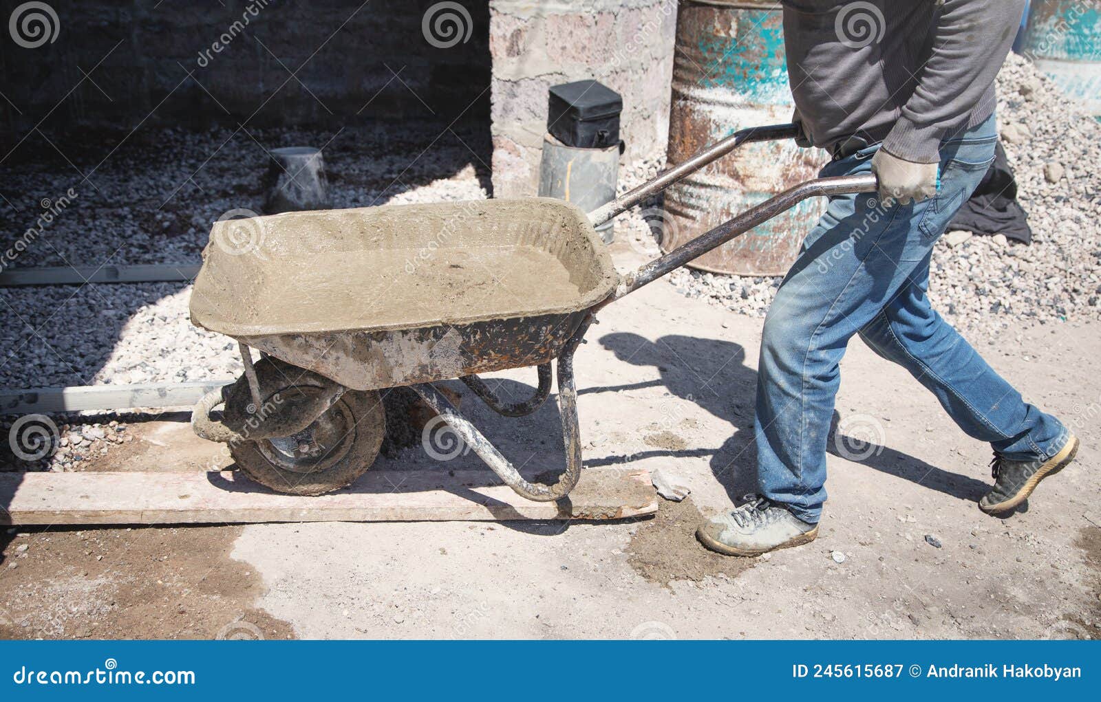 Construction Worker Pushing Wheelbarrow of Cement Stock Image Image