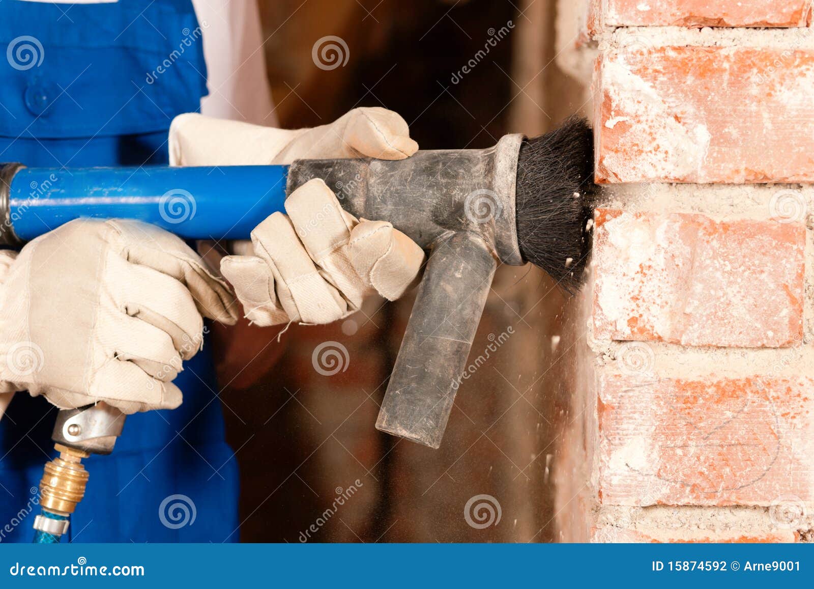 construction worker removing plaster