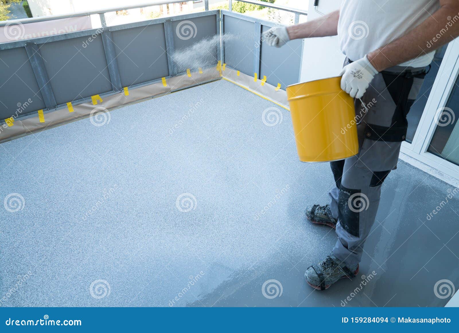 Construction Worker Renovates Balcony Floor And Spreads Chip Floor