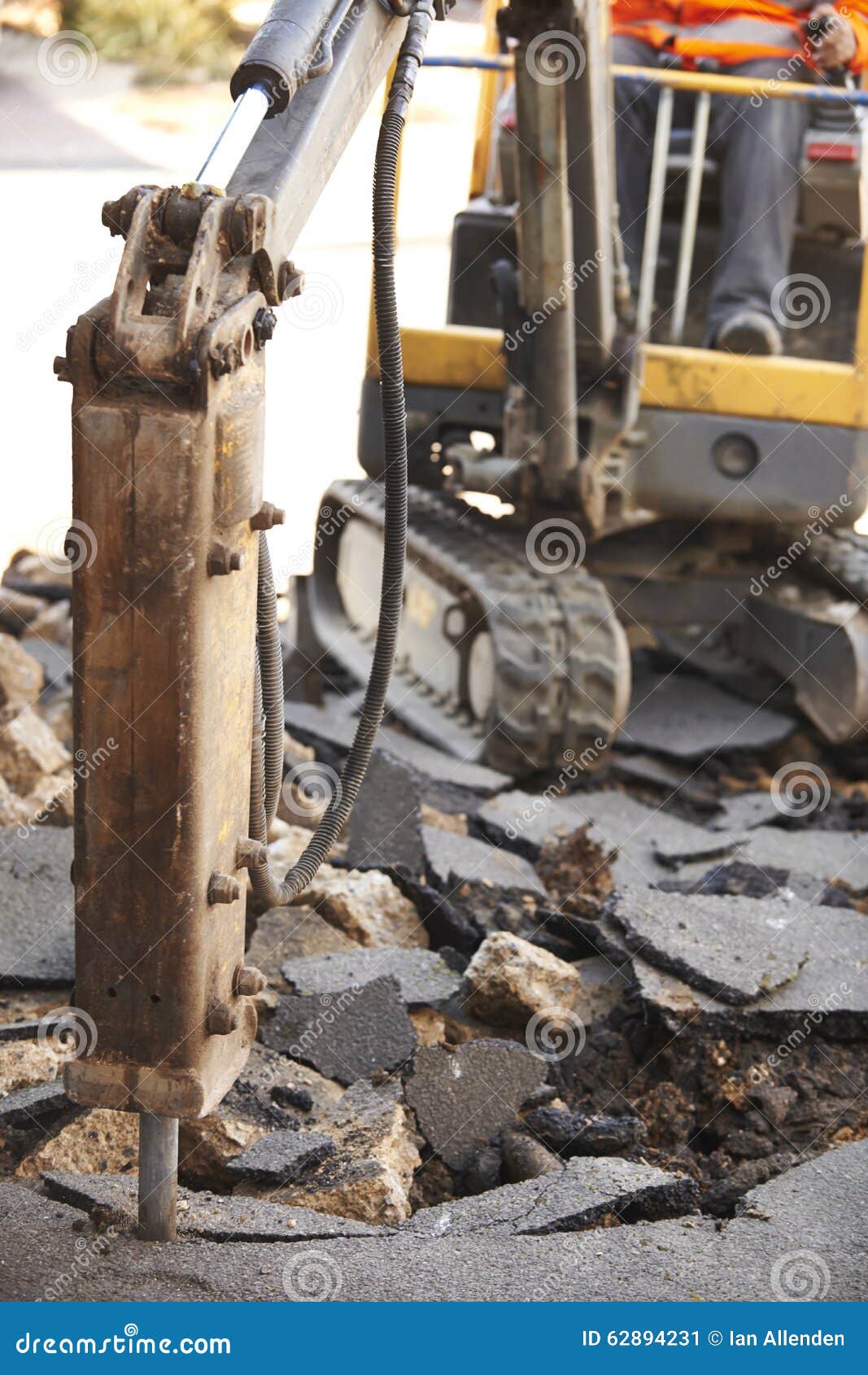 Construction Worker Repairing Road Surface with Jackhammer Stock Image