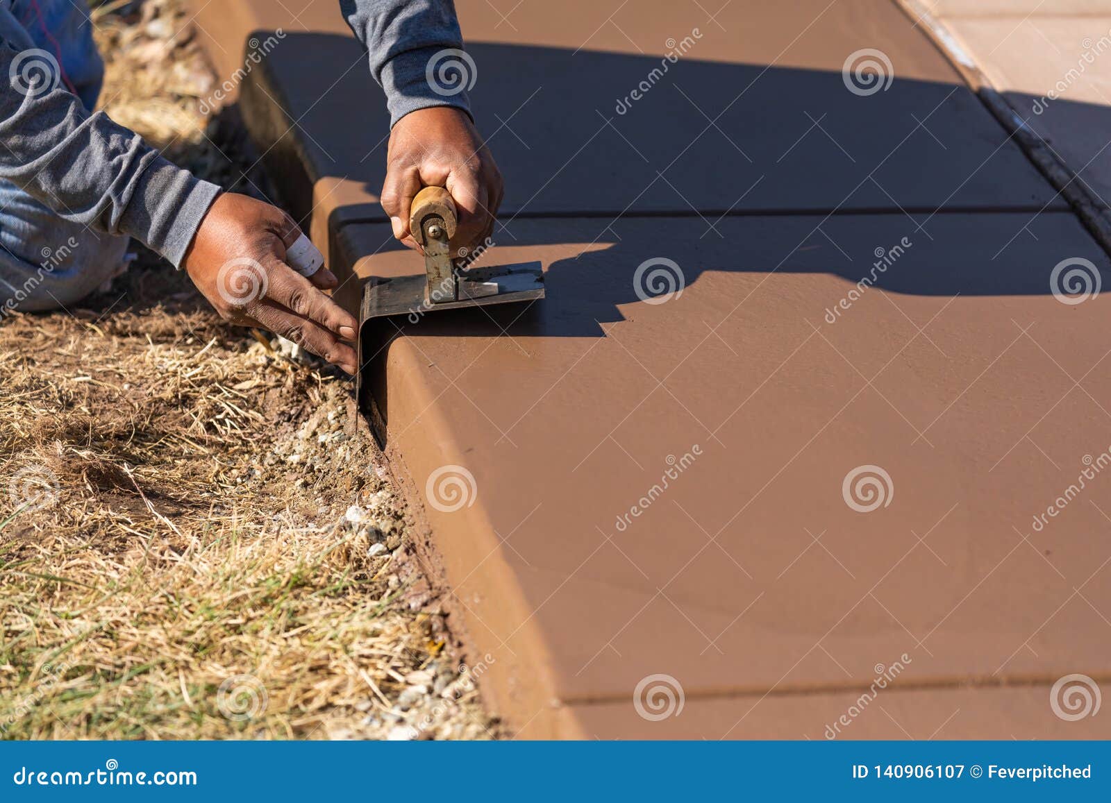 Construction Worker Smoothing Wet Cement with Curb Tool Stock Image