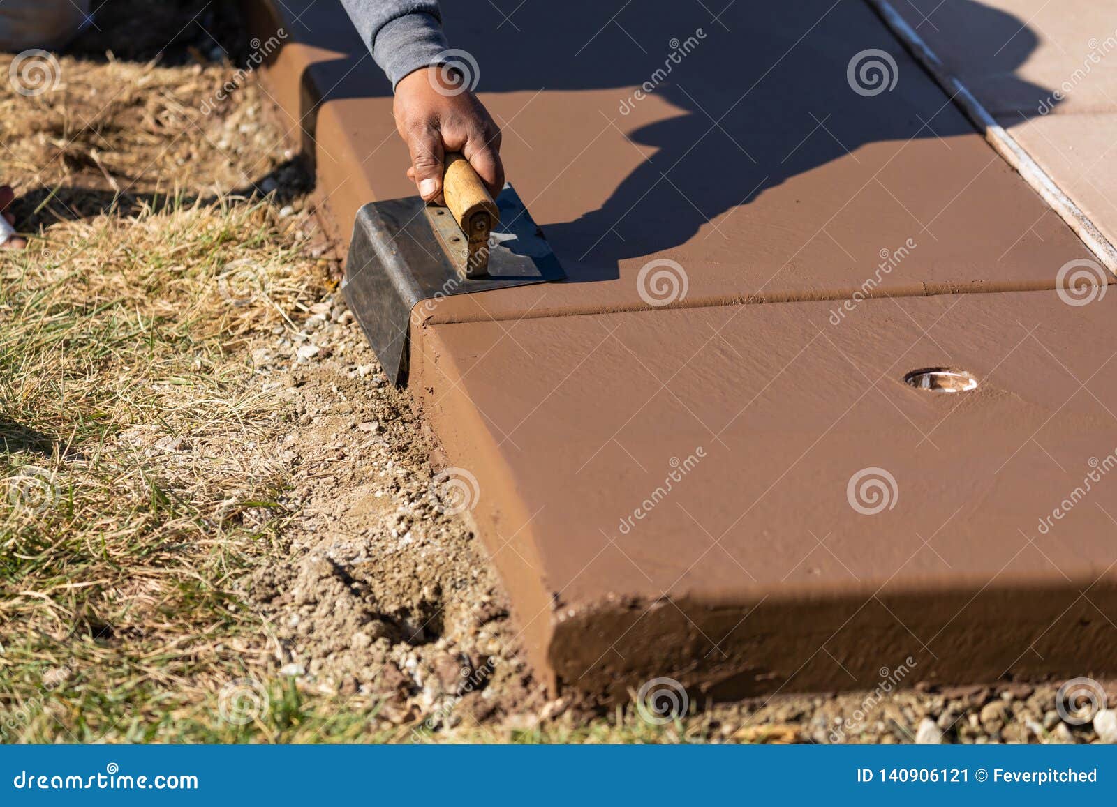 Construction Worker Smoothing Wet Cement with Curb Tool Stock Image