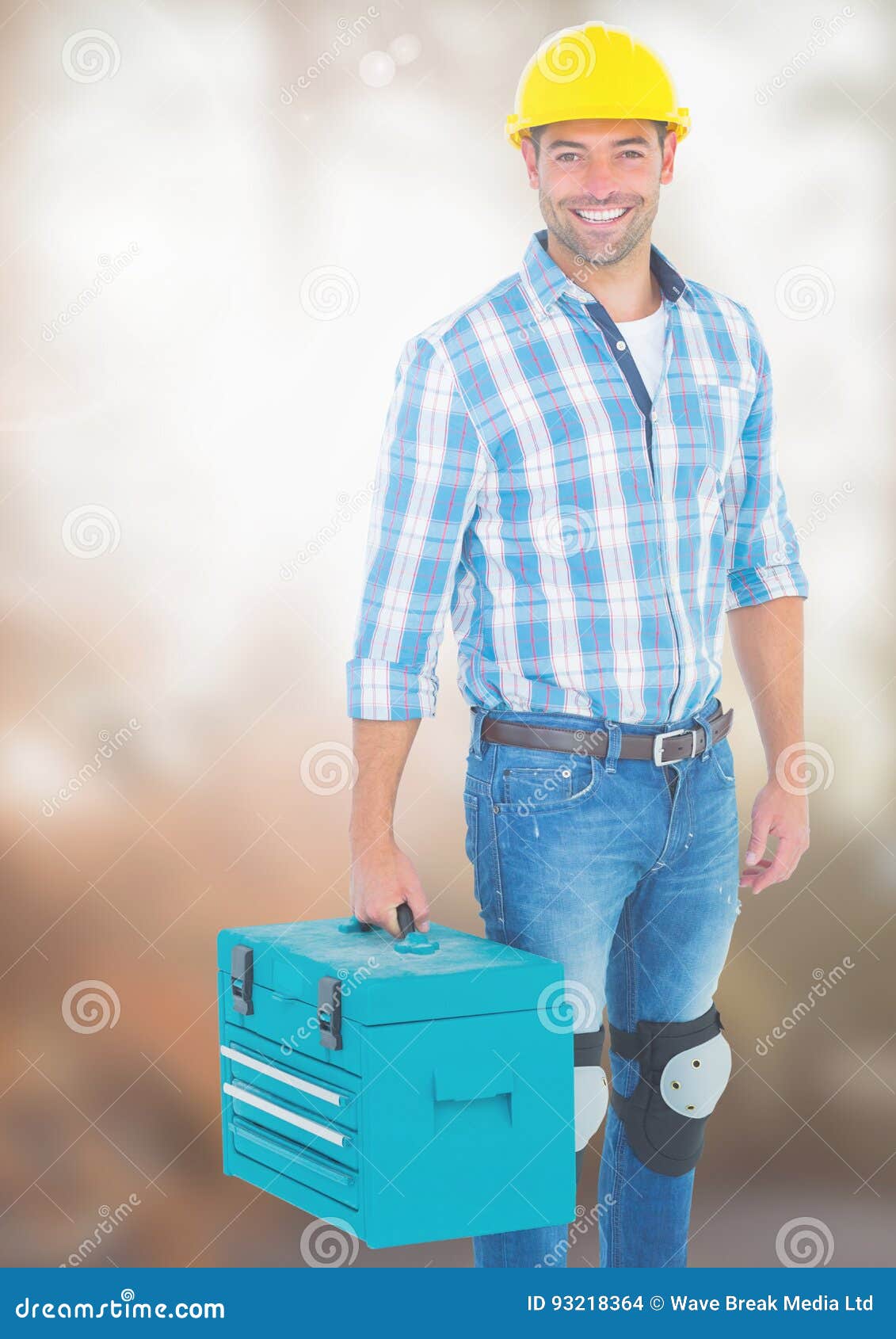 Construction Worker with Tool Box in Front of Construction Site Stock