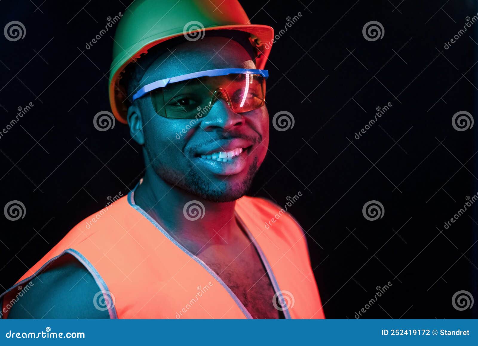 Construction Worker in Uniform and Hard Hat. Futuristic Neon Lighting.  Young African American Man in the Studio Stock Photo - Image of color,  eyewear: 252419172