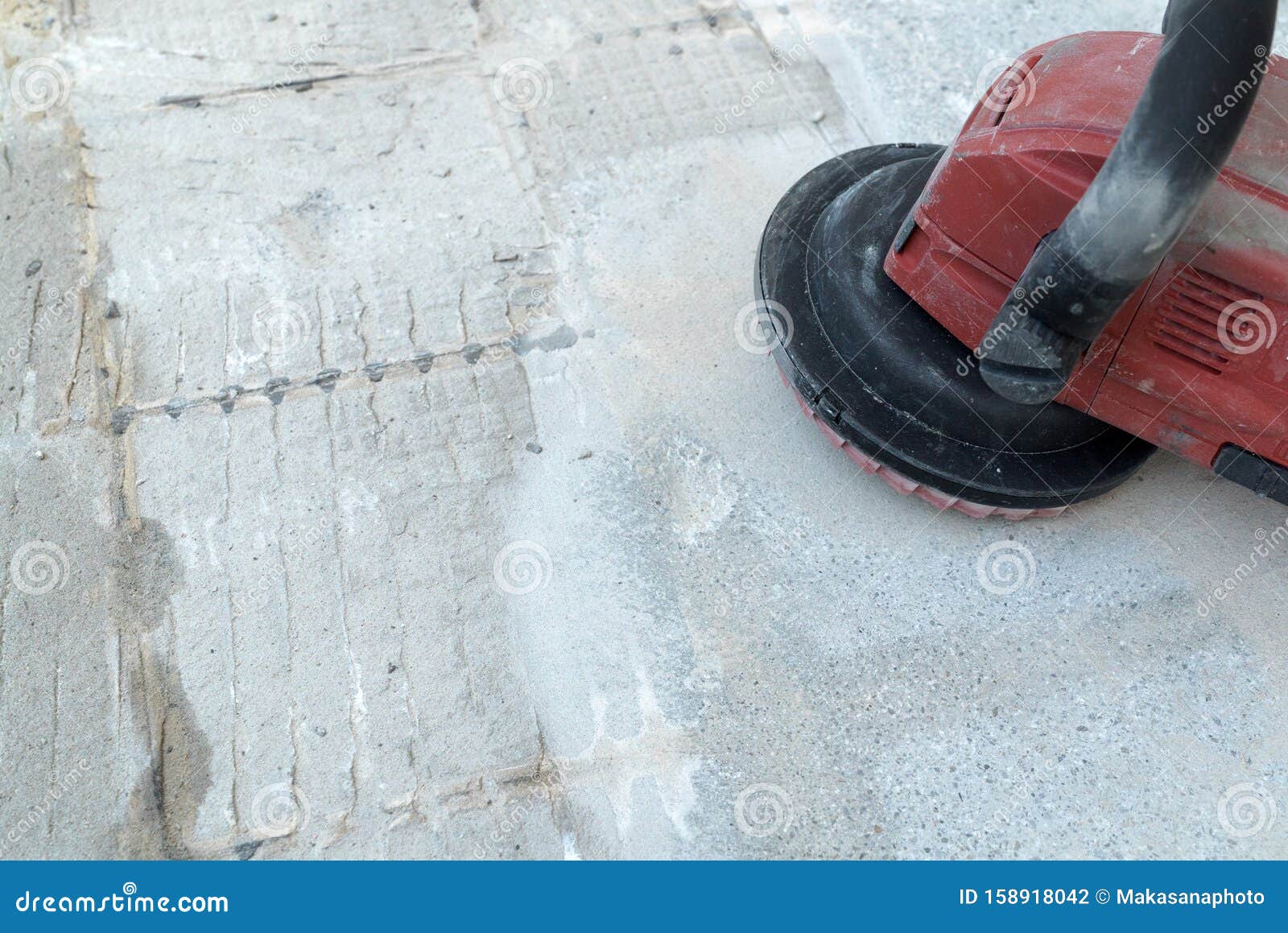 Construction Worker Uses A Concrete Grinder For Removing Tile Glue