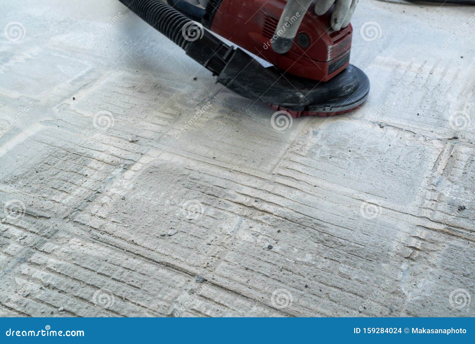Construction Worker Uses A Concrete Grinder For Removing Tile