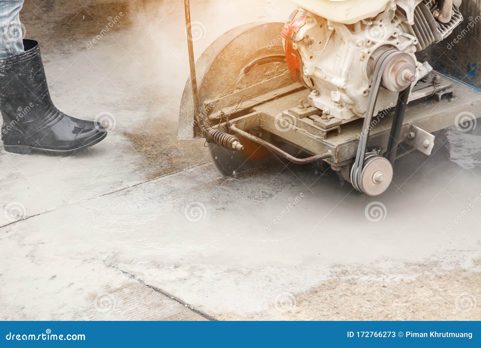 Worker Using Diamond Saw Blade Machine Cutting Concrete Road at