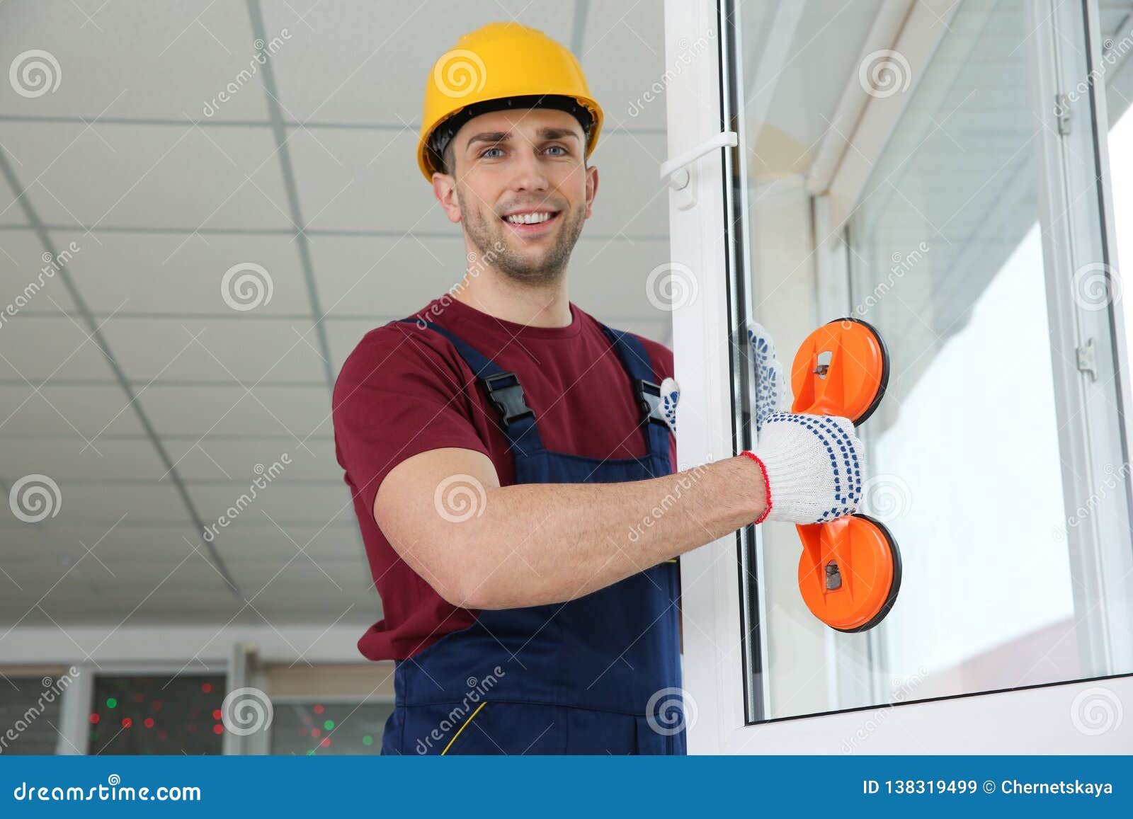 Construction Worker Using Suction Lifter during Window Installation