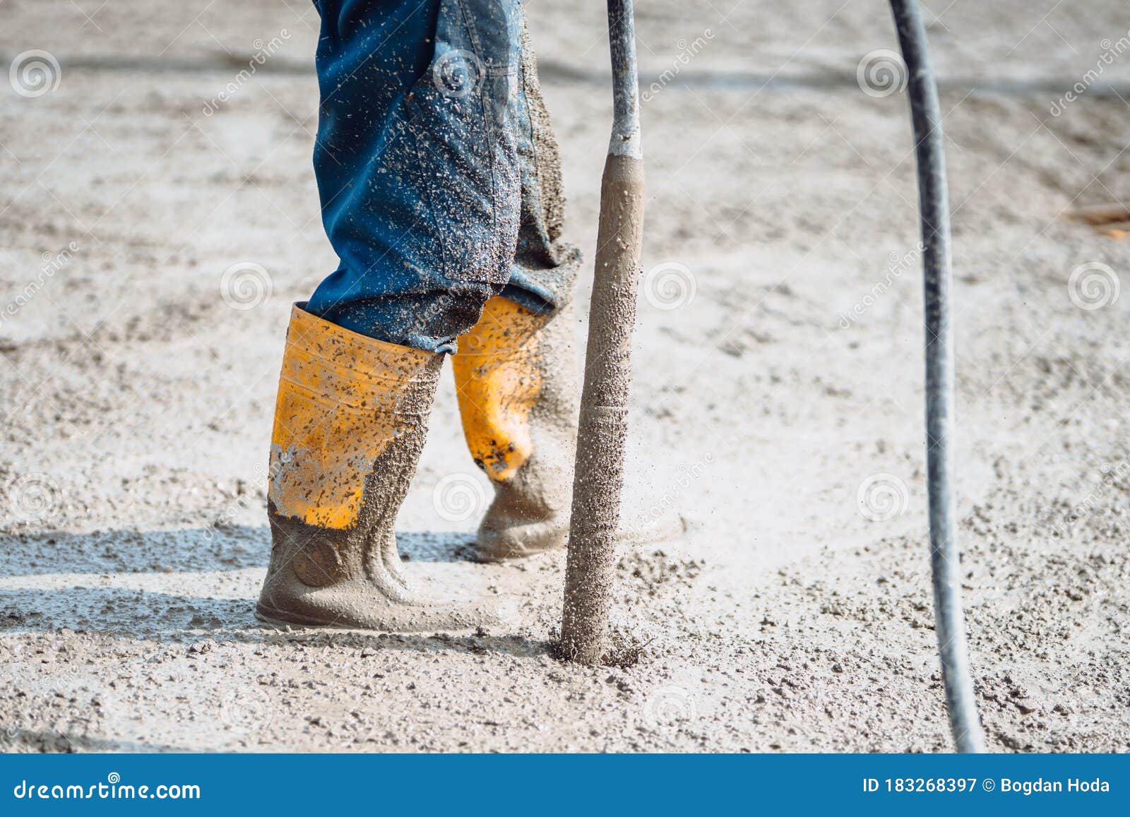 Worker Vibrating Cement Slab. Worker Using Concrete Vibrator Stock
