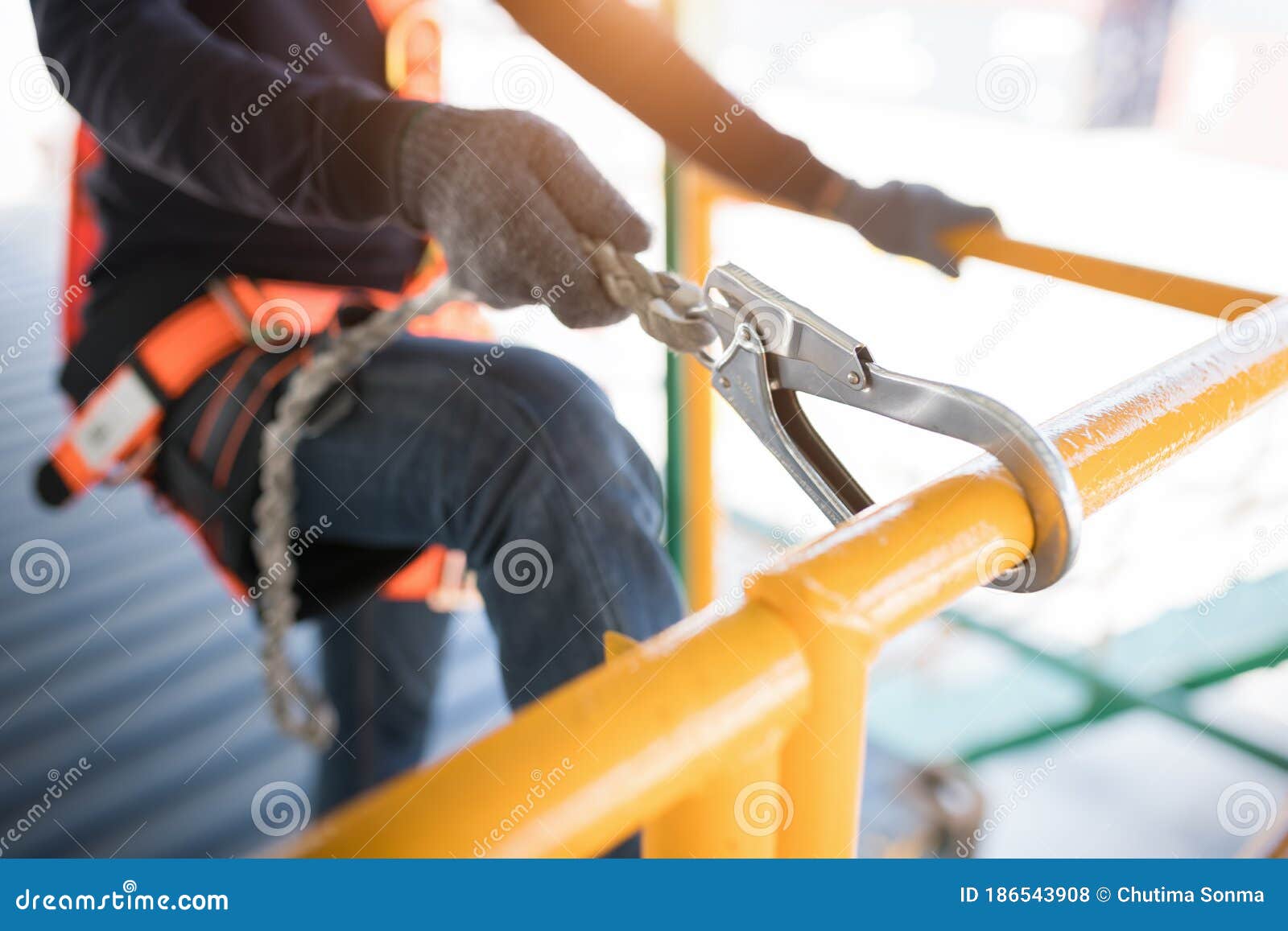 Construction Worker Wearing Safety Harness and Safety Line Working at
