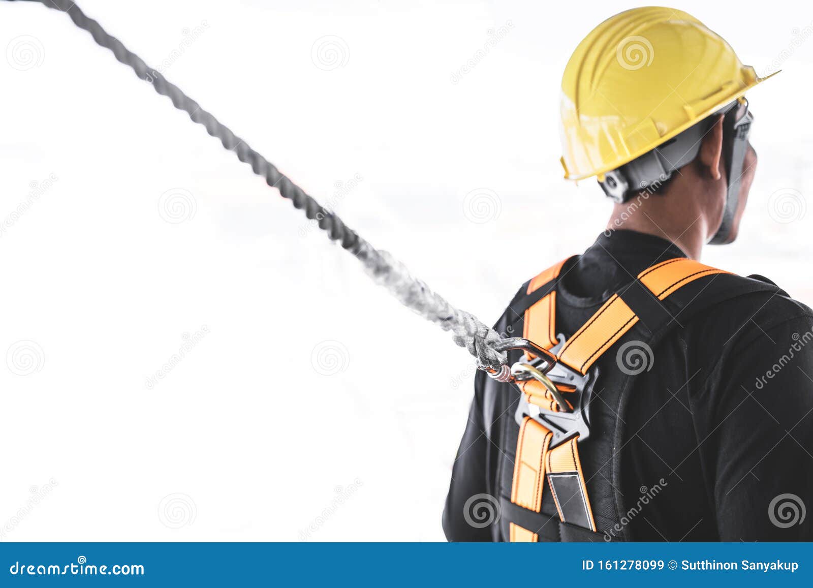Construction Worker Wearing Safety Harness and Safety Line Working at